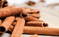 Closeup detail - Heap of cinnamon bark sticks on linen tablecloth