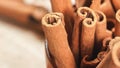 Closeup detail - Heap of cinnamon bark sticks in wooden cup