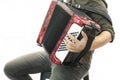 Closeup detail of a man in a black shirt playing the red accordion Hand close-up Royalty Free Stock Photo