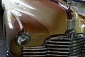 Closeup detail of massive front mask and round headlights of american full size retro car Pontiac Torpedo from year 1946