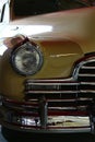 Closeup detail of massive front mask and round headlights of american full size retro car Pontiac Torpedo from year 1946