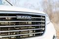 Closeup detail photo of HAVAL logo on the hood of the car Haval H9. Shallow focus
