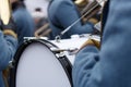 Closeup detail of retro weared standing back soldier drummer with big drum and other soldiers background