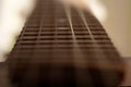 Closeup detail of steel guitar strings and frets for making music. Selective focus on one guitar threshold Royalty Free Stock Photo