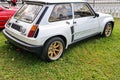 Closeup of details of white vintage historic Renault 5 Turbo 2 car parked on the grass