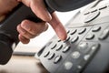 Closeup of dialing a telephone number on a black landline telephone Royalty Free Stock Photo