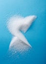 Closeup different shapes of sugar on blue background