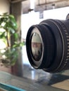 Closeup of digital camera lens side view,blurred background,photography equipment Royalty Free Stock Photo