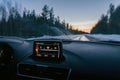 Closeup of a digital compass on a dashboard of a modern car driving through a forest Royalty Free Stock Photo