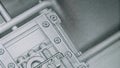 A closeup of a digital twin representation on a screen showing intricate details of a robotic assembly unit complete