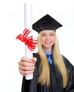 Closeup on diploma in hand of young woman in graduation gown Royalty Free Stock Photo