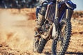 Closeup, dirt track and wheels of motorcyclist with motorbike for race, extreme sports or outdoor competition. Legs of Royalty Free Stock Photo