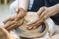 Closeup of Dirty Male Hands Working with Lump of Clay on Potter Wheel Royalty Free Stock Photo