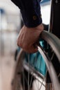 Closeup of disabled paralyzed businessman hands in wheelchair Royalty Free Stock Photo
