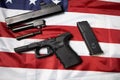 Closeup of disassembled pistol on the American flag. Gun laws in the USA. Handgun parts. Top view disassembly weapon.