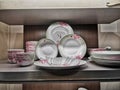 Closeup of dishes and bowls on wooden shelves