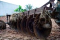 Closeup disk harrows on the back of tractor. Dirty steel blades of tractor