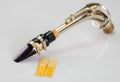 Closeup dismantled mouth piece from saxophone and two reeds lying on white surface Royalty Free Stock Photo