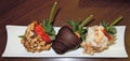 Closeup of a display of individual dipped Strawberries with Macadamia nuts, chocolate and coconut flakes