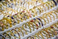 Closeup of a display of intricately designed gold bracelets in a shop