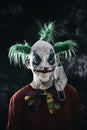 Disturbing evil clown wearing a face mask