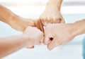 Closeup of diverse group of people making fists in a circle to express unity, support and solidarity. Hands of Royalty Free Stock Photo