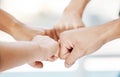 Closeup of diverse group of people making fists in a circle to express unity, support and solidarity. Hands of Royalty Free Stock Photo