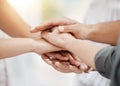 Closeup of diverse group of people stacking hands together in a pile to express unity, support and trust. Multiracial Royalty Free Stock Photo