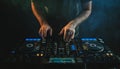 Closeup of a DJ working under the lights against a dark background in a studio