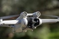 Closeup of the DJI Mini 3 Pro aerial drone against the blurred trees background