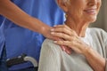 Closeup of a doctor comforting and supporting a patient by holding hands. Healthcare professional showing kindness to an