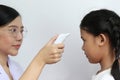 Closeup of Doctor examines or treatment child patient temperature in the ear using electronic thermometer on white background, Royalty Free Stock Photo