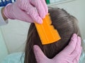 Closeup of doctor examining girl hair with comb Royalty Free Stock Photo