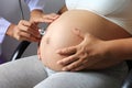 Closeup of doctor hand holding stethoscope to checking pregnant Royalty Free Stock Photo