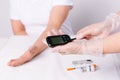 A closeup of doctor hands prepares to performing an insulin test on a patient in the hospital. White background and