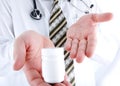 Closeup, doctor holding little pills bottle