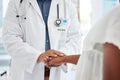 Closeup on doctor holding a patients hand. African american doctor being kind to a patient cropped. Doctor offering a