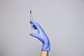 Closeup doctor's hand in rubber latex purple glove hold transparent syringe. Isolated on white background. Concept rejection of