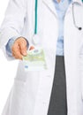 Closeup on doctor woman giving euros Royalty Free Stock Photo