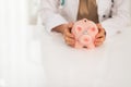 Closeup on doctor woman holding piggy bank Royalty Free Stock Photo