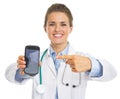 Closeup on doctor woman pointing on mobile phone Royalty Free Stock Photo