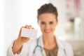 Closeup on doctor woman showing business card Royalty Free Stock Photo