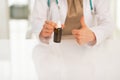 Closeup on doctor woman showing medicine bottle Royalty Free Stock Photo