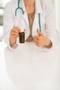 Closeup on doctor woman showing medicine bottle an Royalty Free Stock Photo