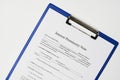 Closeup of a document entitled Interest promissory note on a blue clipboard Royalty Free Stock Photo