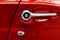 Closeup door handle of red Thunderbird retro car