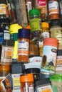 Closeup on a drawer with many small bottles with various spcies used for making food