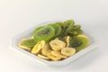 Closeup of dried slices of kiwi and banana, dried fruits, white background, healthy food Royalty Free Stock Photo