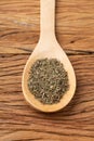 Closeup of dried thyme on a spoon over wooden table Royalty Free Stock Photo