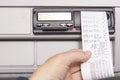 Closeup of a driver getting his printed driving dates from a tachograph